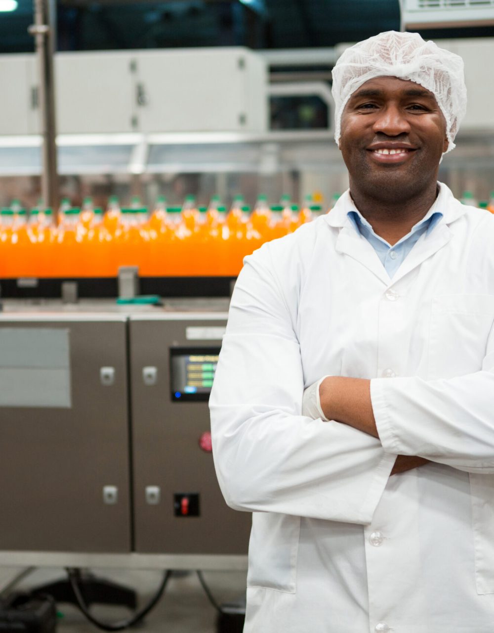 Portrait of confident male worker standing in juice factory Portrait of confident male worker standing in juice factory